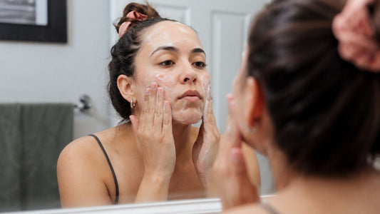 Woman washing her face with a gentle cleanser to support sensitive skin comfort and daily cleansing.