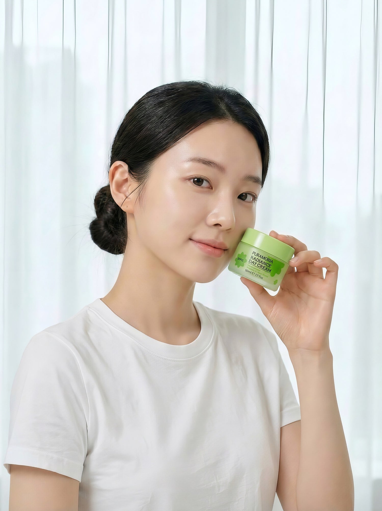 Model holding Puramoria Niacinamide Brightening Day Cream for daily dry skin brightening and moisturizing