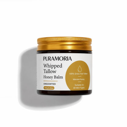 Front view of PURAMORIA Whipped Tallow Honey Balm in a 120g amber jar labeled grass-fed tallow and Manuka honey.